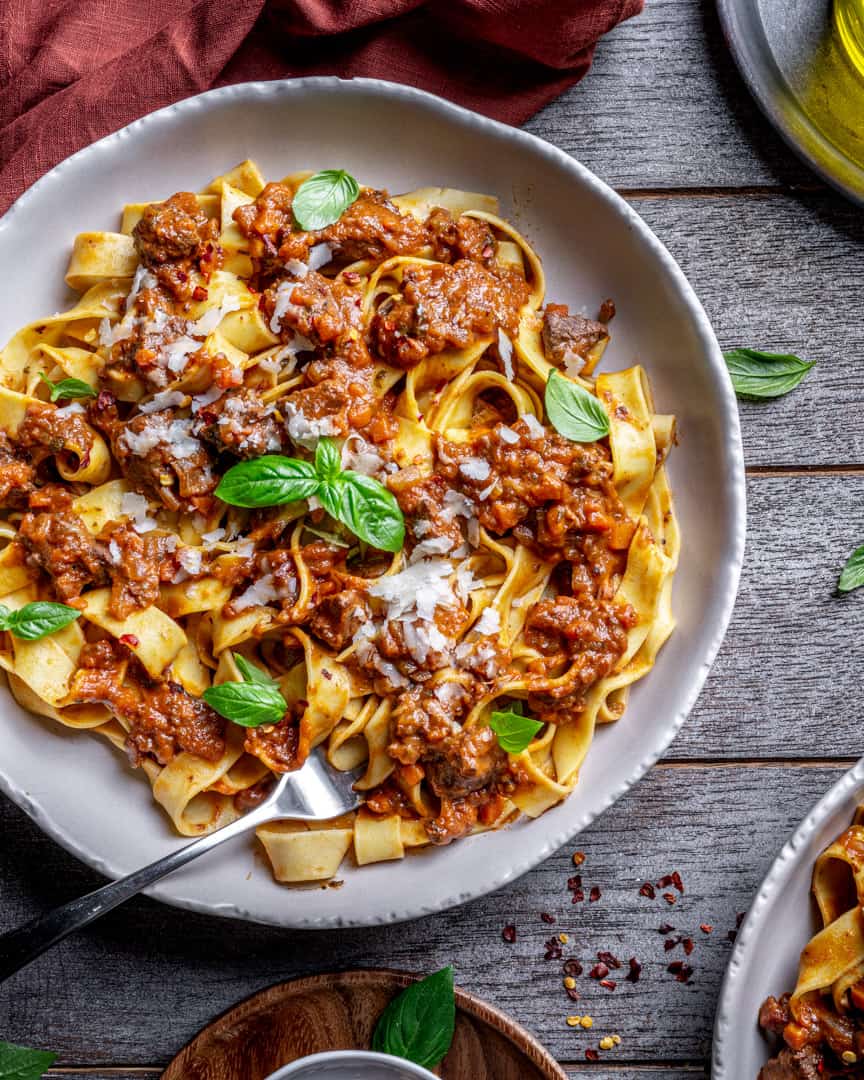 Red Wine Slow Braised Italian Beef Ragù with a glass of Chianti Classico red wine