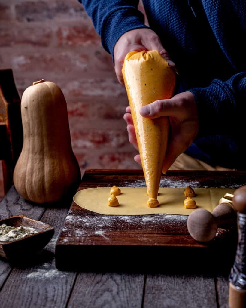 Filling homemade butternut squash ravioli